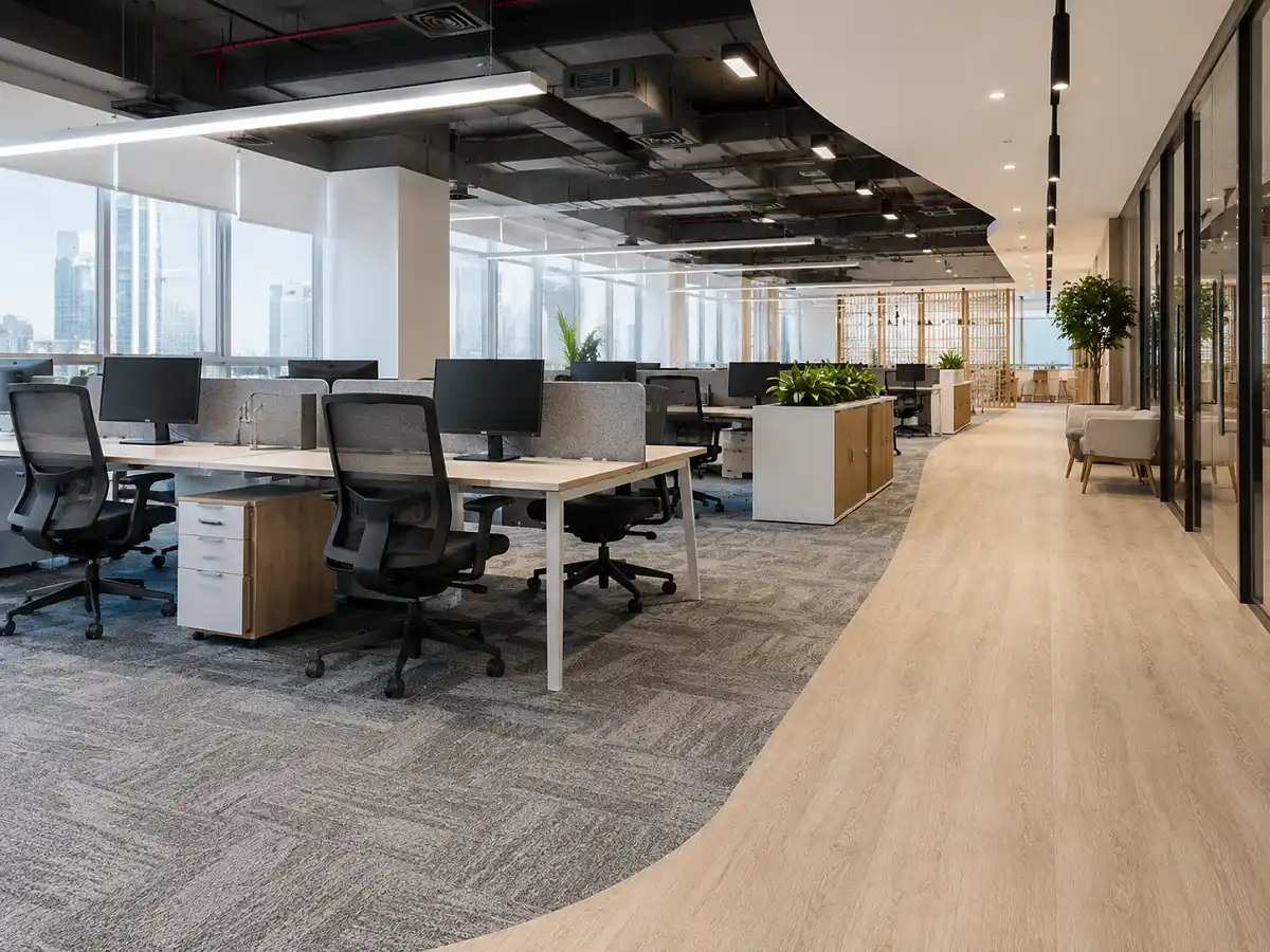 Commercial office flooring in a UAE workplace with carpet tiles and LVT zones